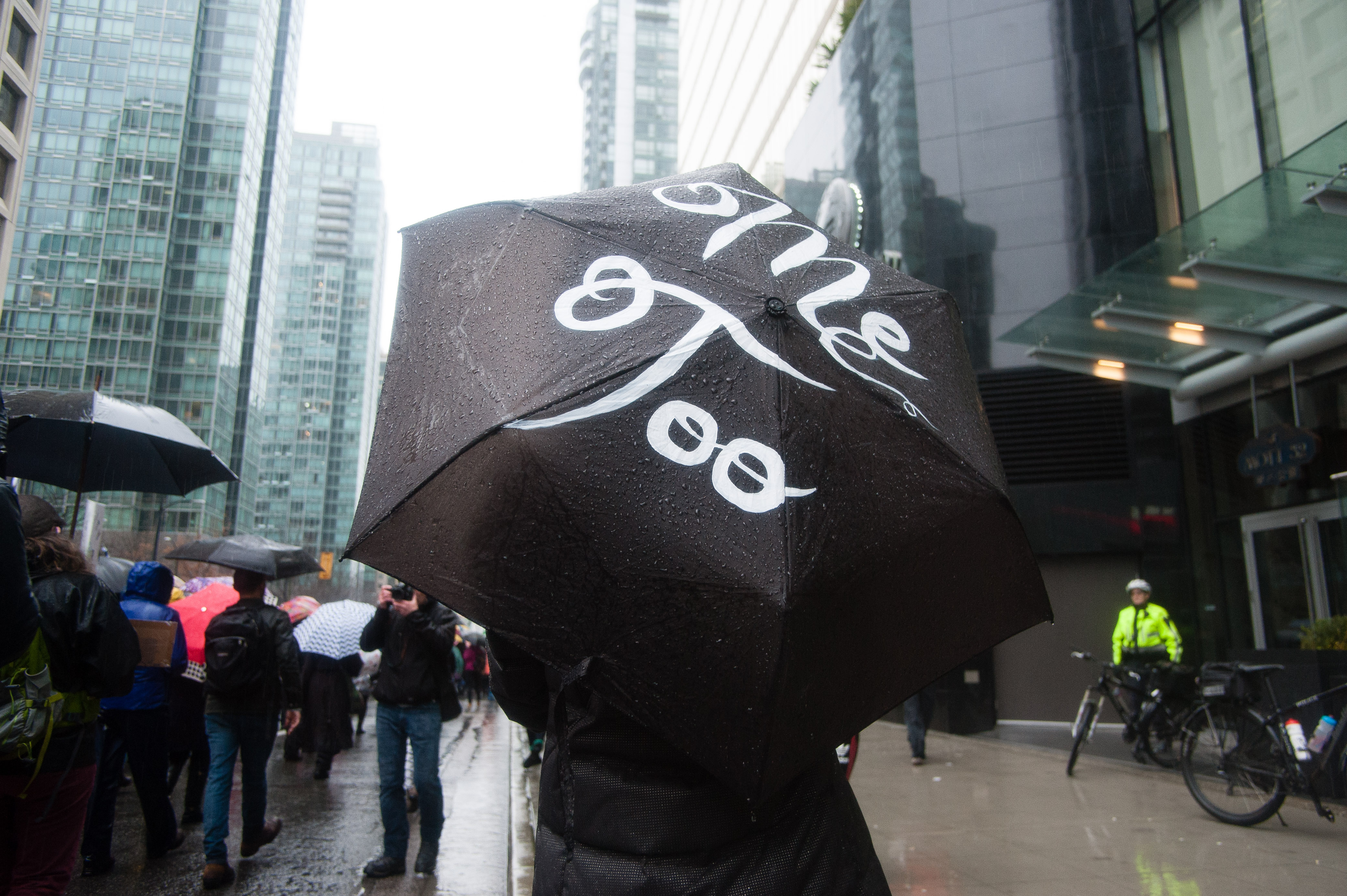 Prepared for the rain, many demonstrators wrote messages on their umbrellas. Here a woman displays a reference to the #MeToo movement in front of Trump Tower.